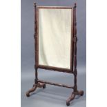 A Victorian cheval mirror, the plain rectangular plate in cushion-fronted frame, & on turned