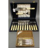 A stainless steel cutlery set, settings for six, with a pair of carvers in fitted case; & a set of