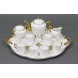 A late 19th century Limoges porcelain white ground & gilt decorated cabaret, with settings for
