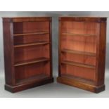 A NEAR PAIR OF VICTORIAN MAHOGANY STANDING OPEN BOOKCASES, each with moulded cornice, fluted break-