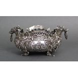 A continental silver rococo style oval bowl with all-over embossed figure & scroll decoration,