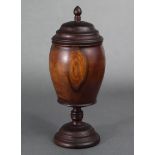 A 19th century turned yew wood tea caddy of ovoid form, with removable cover, & on pedestal foot;