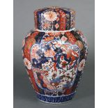 A 19th century Japanese Imari ginger jar & cover, the fluted ovoid body decorated with foliage &