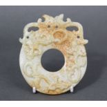 A Chinese pale green & russet jade flat round bi-form pendant carved with three chilong nose-to-