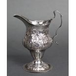 A George III silver cream jug of inverted pear shape with flared rim & spout, scroll handle & on