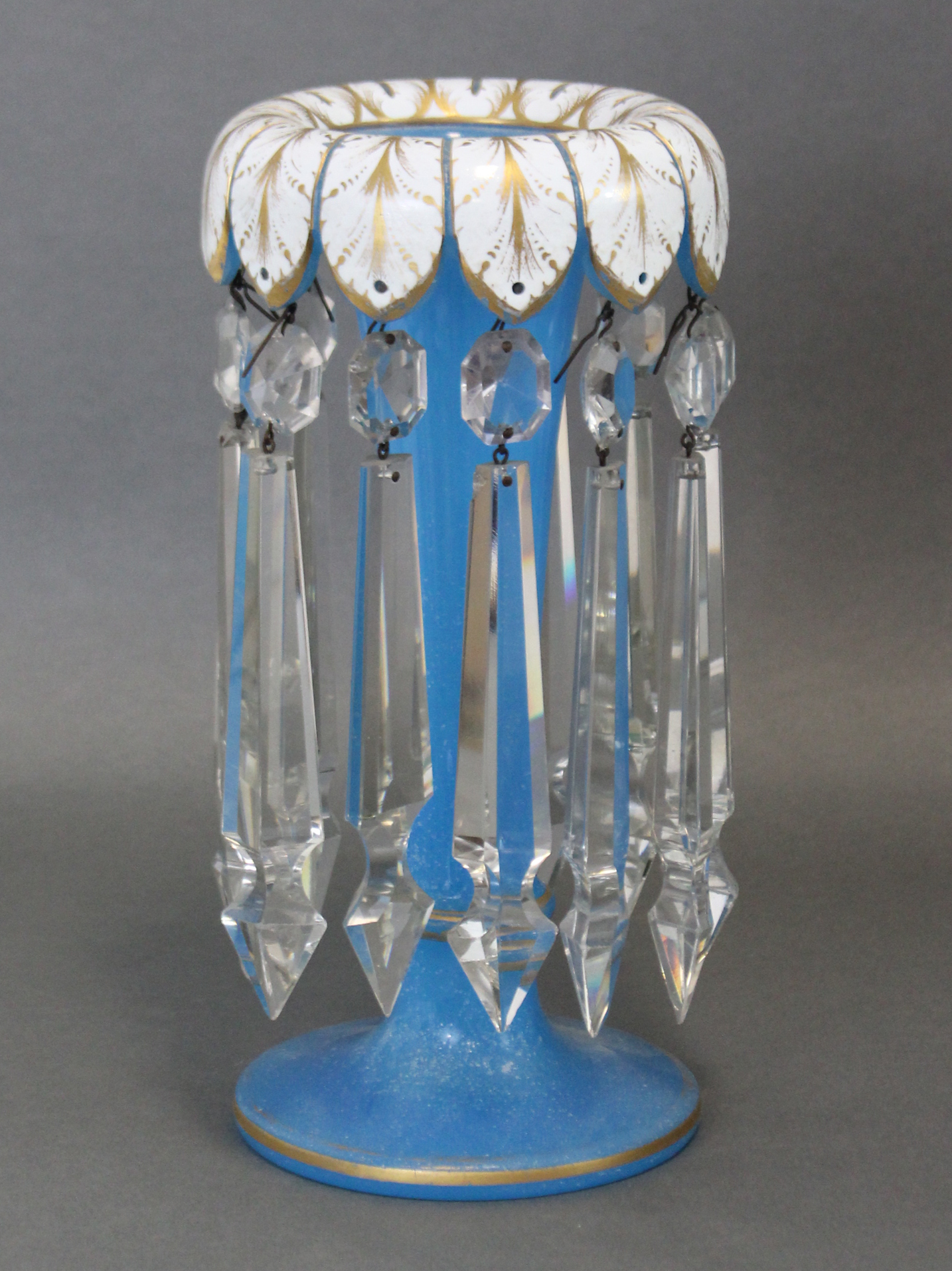 A 19th century bohemian cut-glass candle lustre with blue trumpet-shaped body & white overlaid lobed