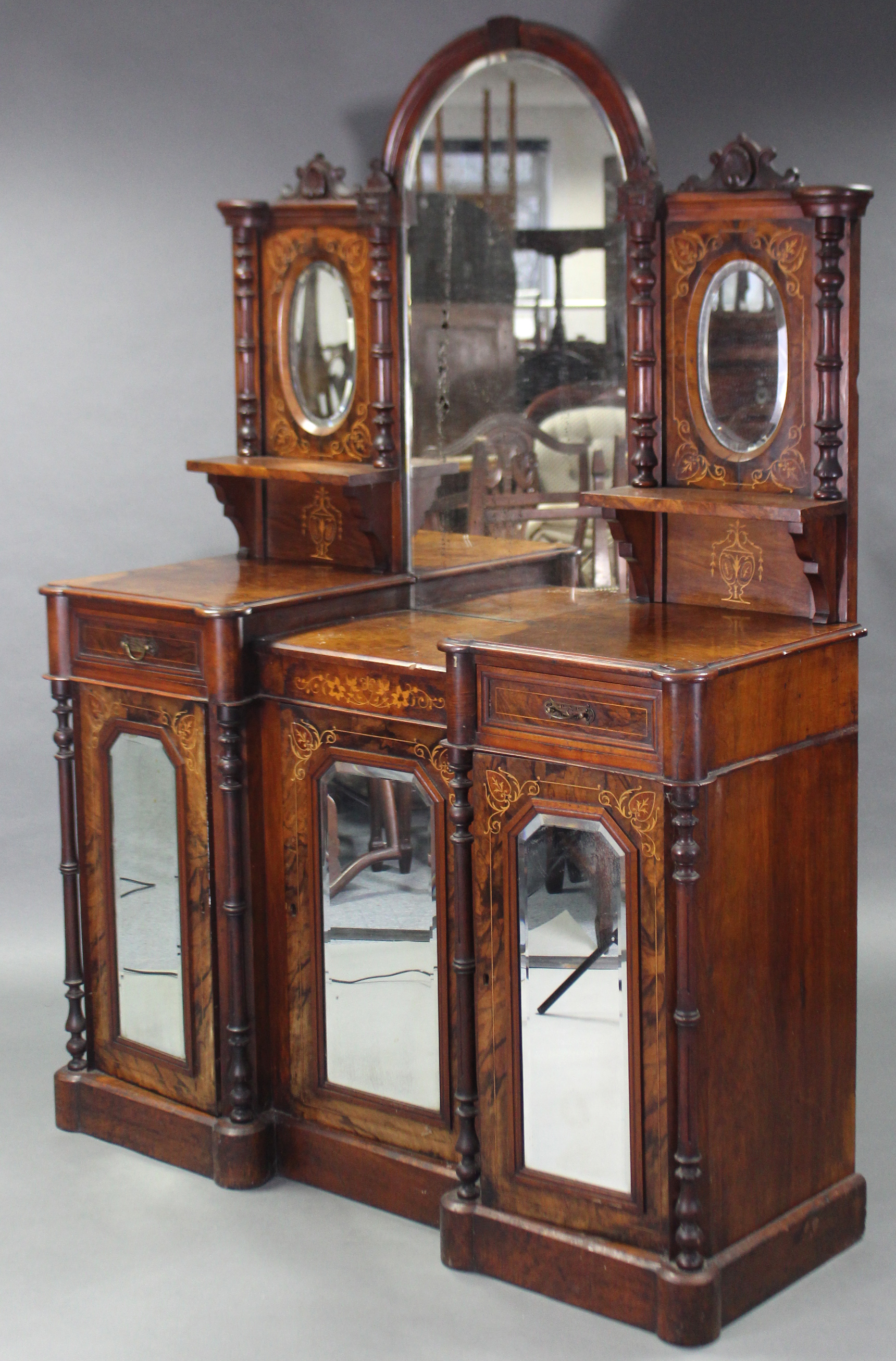 A mid-Victorian inlaid walnut inverted breakfront sideboard, the tall raised back inset three