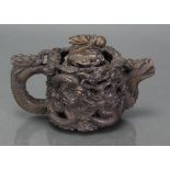 A Chinese soapstone reticulated teapot, deeply carved & pierced with encircling dragons, with