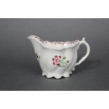 A late 18th century English porcelain ‘Low Chelsea Ewer’ with moulded leaf decoration to the