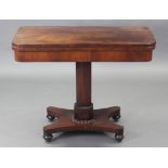 A regency rosewood card table, the rectangular fold-over top inset green baize, on octagonal