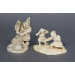 A Japanese carved ivory okimono in the form of two boys lighting a fire-cracker, on shaped flat oval