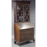 An early 19th century mahogany bureau-bookcase, fitted three adjustable shelves enclosed by pair