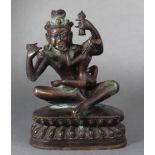 A Tibetan bronze statue of Mahasiddha Ghantapa and Consort, each wearing a skull crown, holding a