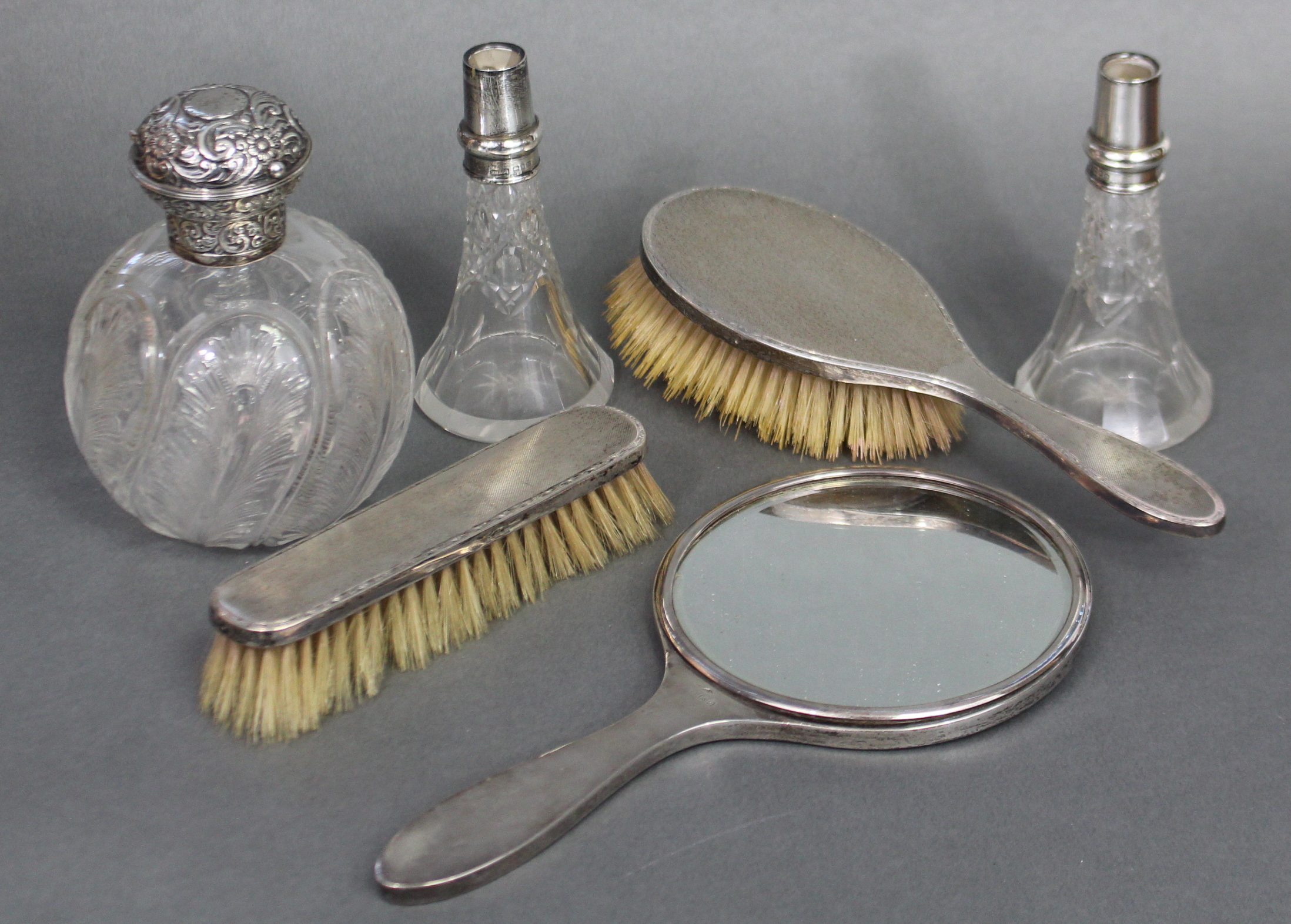 A late Victorian glass spherical toilet-water bottle with finely cut feather motifs, the embossed