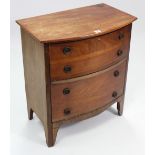 A mahogany small bow-front chest, fitted two long graduated drawers with brass ring handles & on