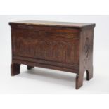A small oak coffer with hinged lift-lid, & carved front & sides, 31” wide x 22” high.