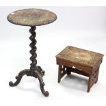 A 19th century carved oak tripod table with circular top, & on barley-twist centre column & three