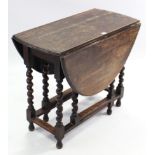 A 1930’s oak oval gate-leg dining table, on barley-twist legs & turned feet with plain stretchers,