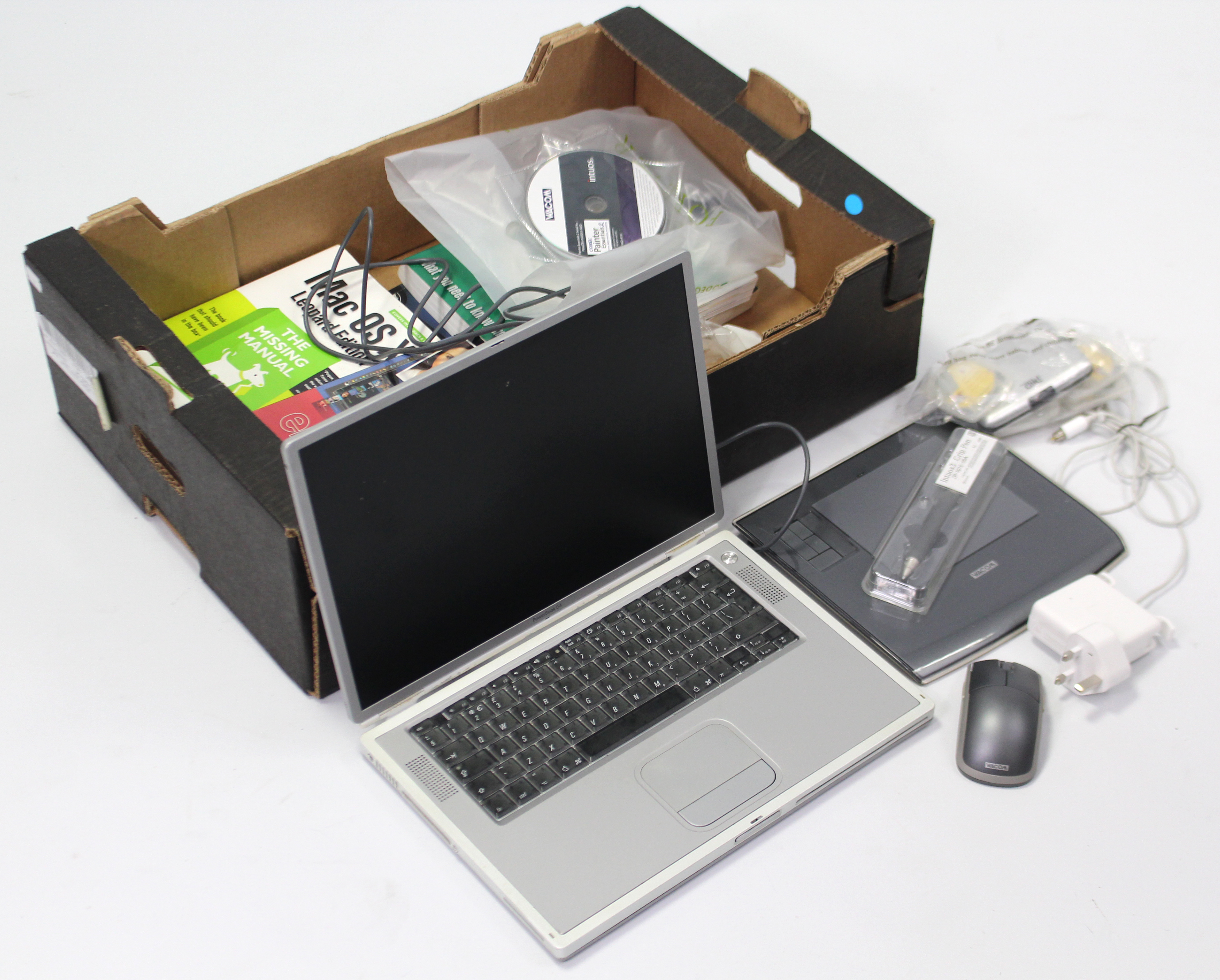 An Apple Mac laptop with various accessories