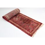 A Persian pattern corridor runner of salmon pink & ivory ground, & with all-over multi-coloured