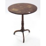 A 19th century oak tripod table with circular top, & on vase-turned centre column & three splay