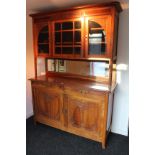 A late 19th/early 20th century continental carved walnut dresser in the art nouveau style, the upper