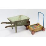 A painted wooden child’s wheelbarrow, 32” long; & a set of child’s painted wooden building bricks