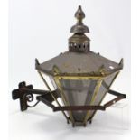 A large oxidised-metal hexagonal wall lantern inset Perspex sides, 32” high, & with cast-iron wall