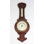 A late 19th/early 20th century aneroid wall barometer the 6” diameter white enamel dial signed “M.