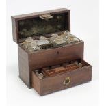 A late 19th century mahogany apothecary’s travelling case part fitted with twelve glass bottles