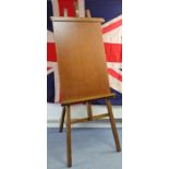 A large wooden studio easel, 83” high.