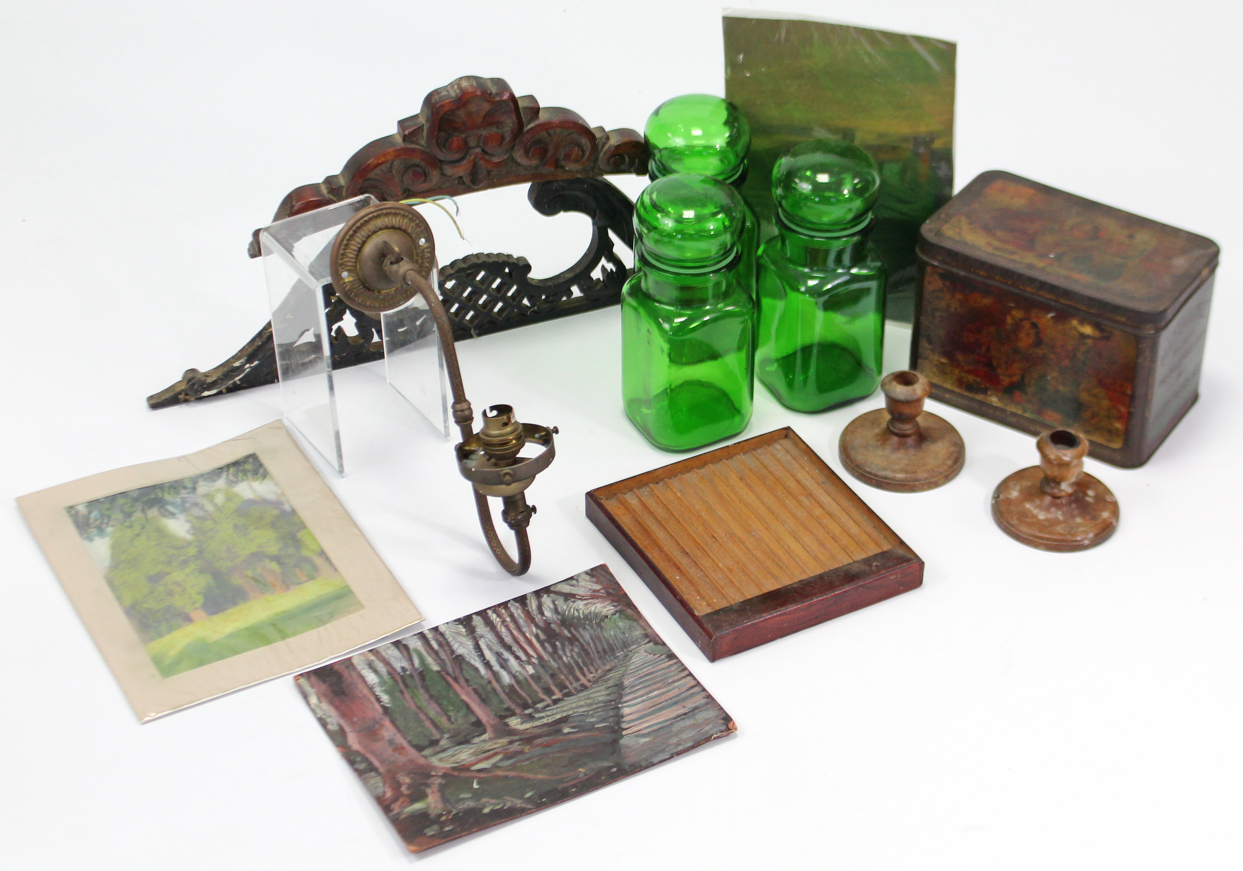 Three green tinted glass storage jars; a “Mazawattee” tea tin; a pair of treen candlesticks; three