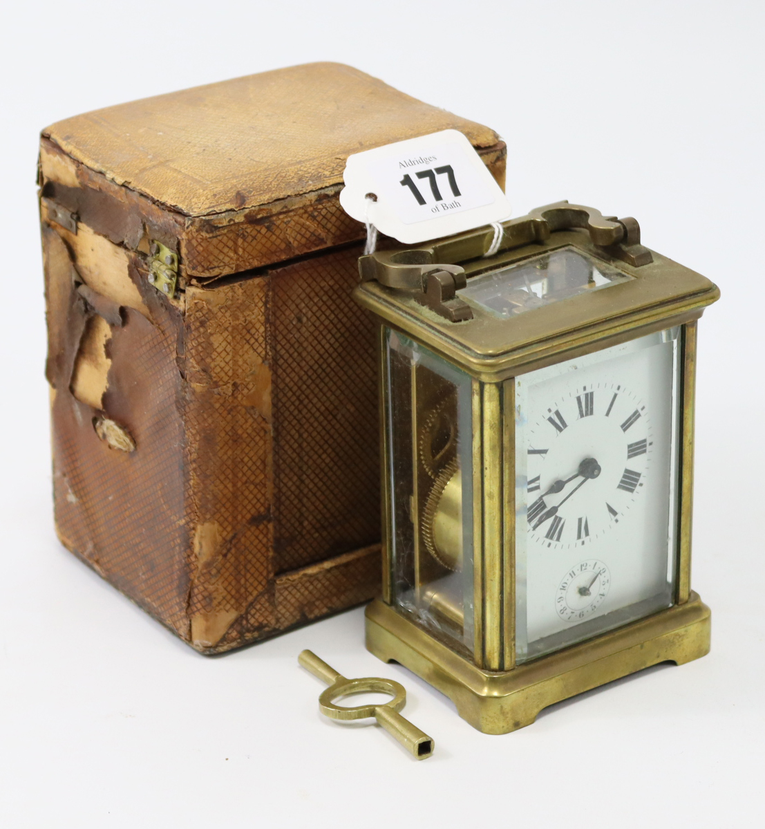 A French brass-cased carriage timepiece, 4¼” high, with travelling case (travelling case w.a.f.).