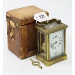 A French brass-cased carriage timepiece, 4¼” high, with travelling case (travelling case w.a.f.).
