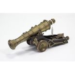 A cast-brass & wooden cannon desk ornament, 16” wide.