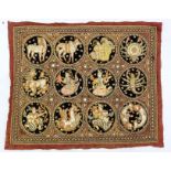 An eastern gold & silvered thread & sequin decorated wall hanging depicting numerous figures &