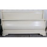 A white-finish king size bedstead, 64” wide, complete with side rails.