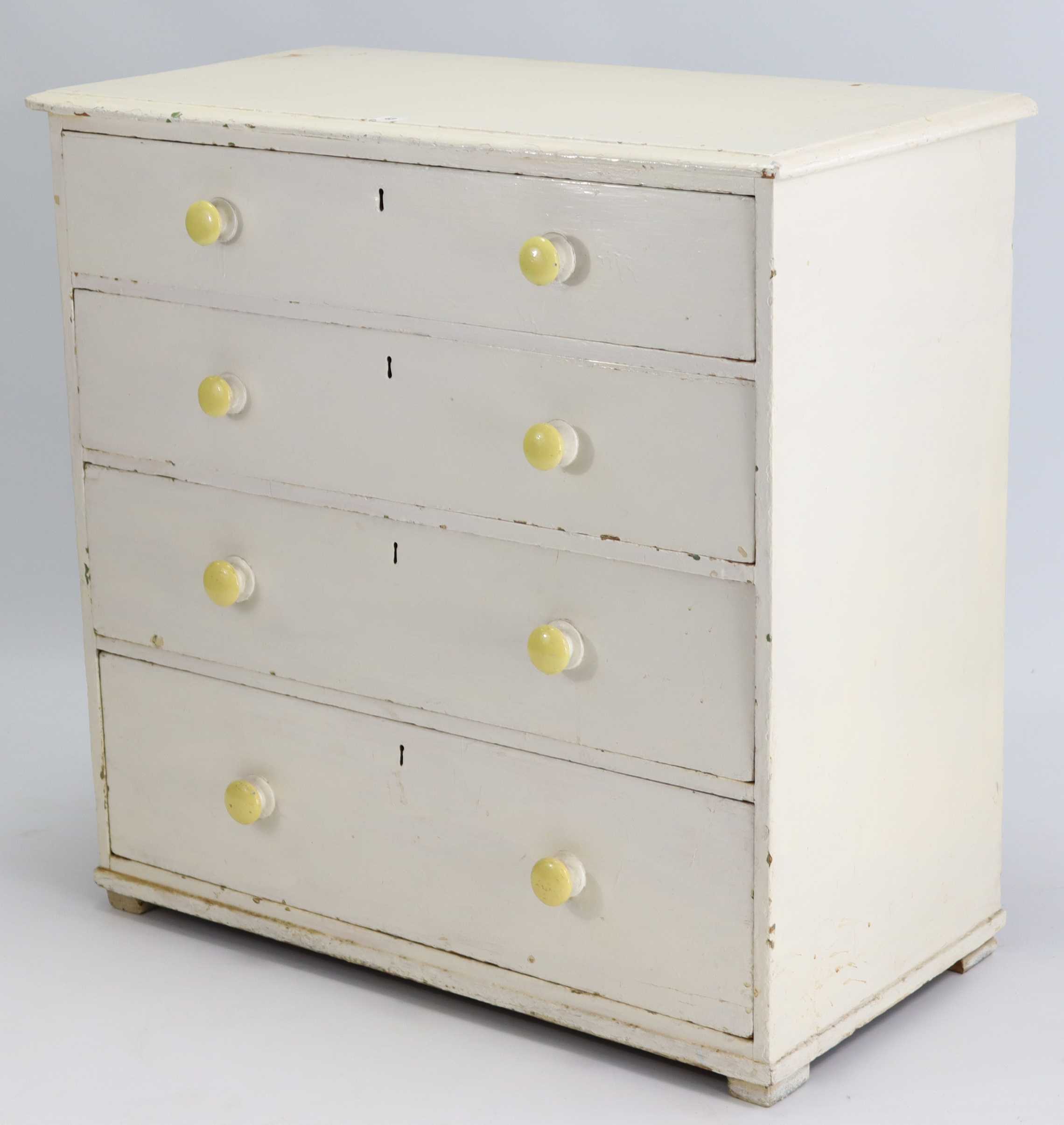 A Victorian white painted pine chest fitted four long graduated drawers with turned knob handles,