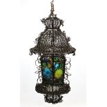 A wrought-iron pendant hall lantern, 32” high; together with four Tilley lamps; a table lamp, etc.