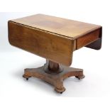 A 19th century mahogany drop-leaf supper table, fitted end drawer & on round tapered centre column &