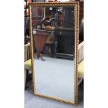 A large gilt frame rectangular wall mirror inset bevelled plate, 50” x 26”.