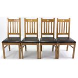 A set of four modern rail-back dining chairs with padded seats, & on square legs with plain