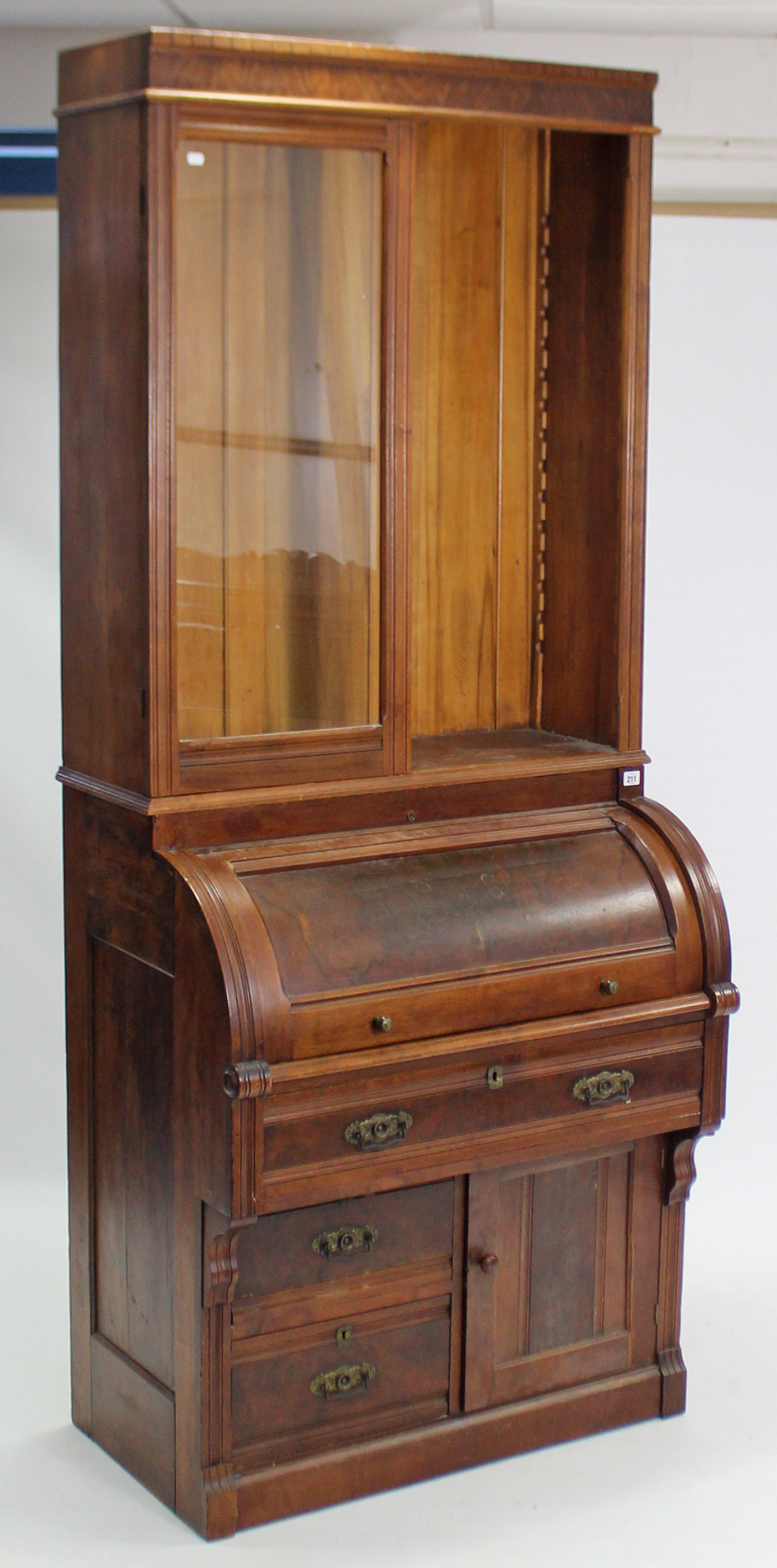 A 19th century tall bookcase the upper part with three adjustable shelves (lacking one glazed