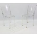 A pair of Italian “La Marie” clear Perspex dining chairs by Starck for Kartell; & a similar