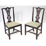 A pair of Georgian mahogany splat-back dining chairs with padded drop-in-seats, & on square