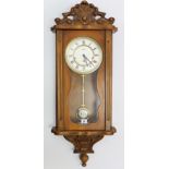 An Astra reproduction wall clock with white enamel dial, & in carved wooden case, 37½” high; & a