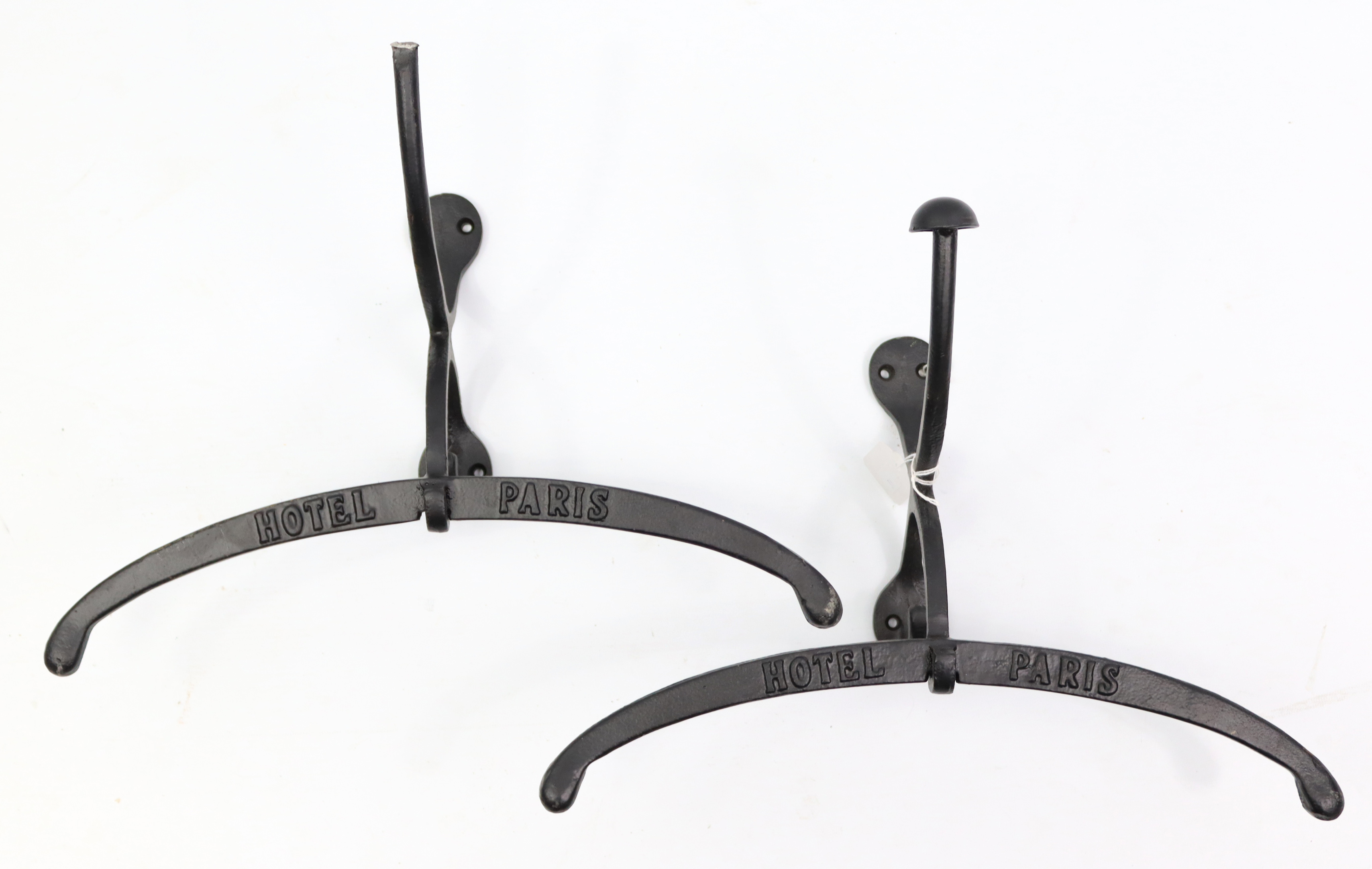A pair of modern cast-iron “Hotel Paris” valet hooks, 15” wide.