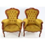 A pair of continental-style armchairs, with buttoned backs & sprung seats upholstered bronzed