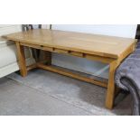 A light oak farmhouse table with rectangular top, fitted two frieze drawers to one side & on