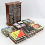 Approximately eighty various CDs with a mahogany CD stand; & approximately one hundred various